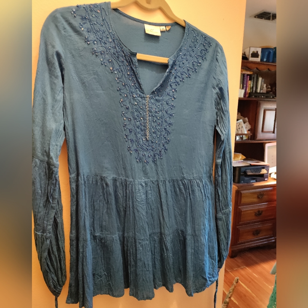 Loose fitting women's top, sequins and embroidery stitching around neck area